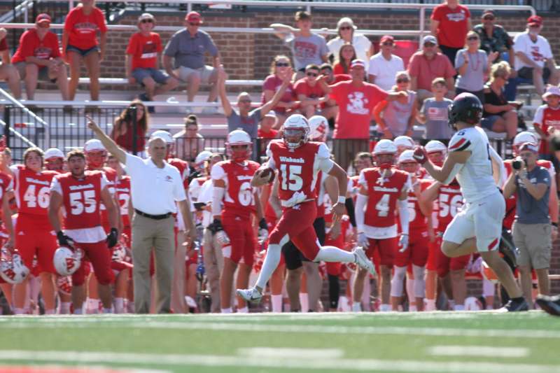 a football player running with his team in the background