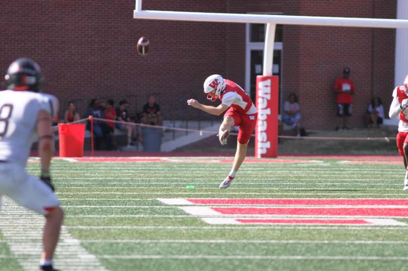 a football player kicking a football on a field