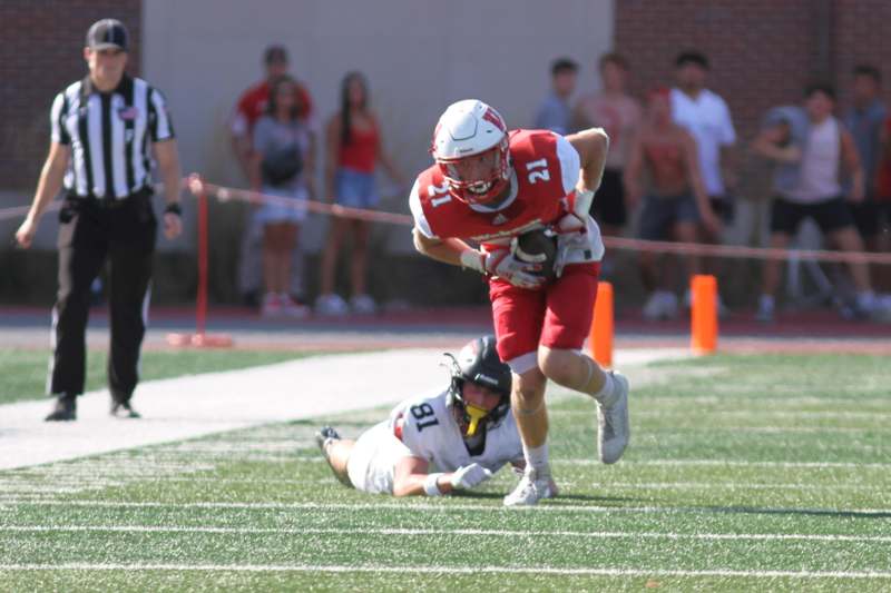 a football player running with a football