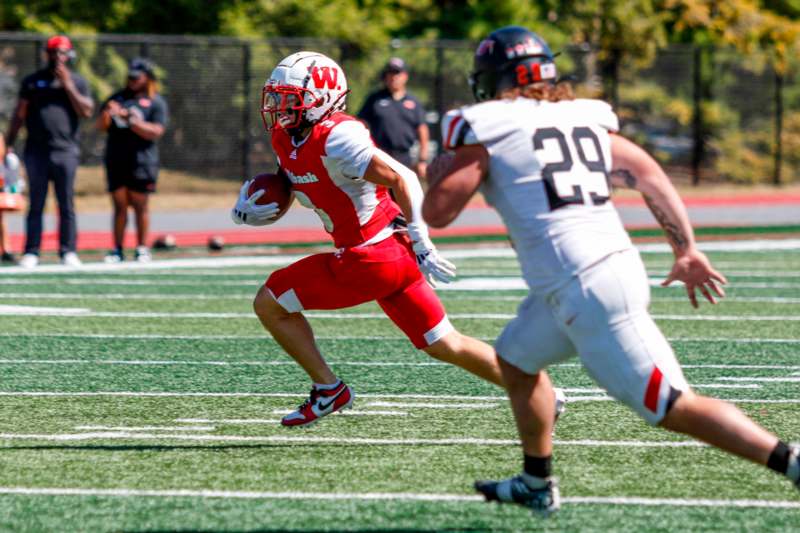 a football player running with a football