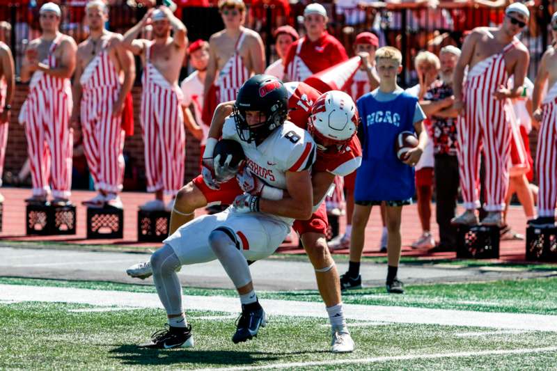 a football player carrying another football player