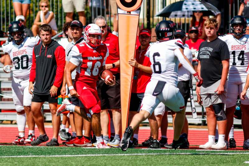 a football player running with a football in the back