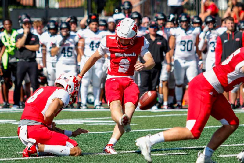 a football player running with a football in the air