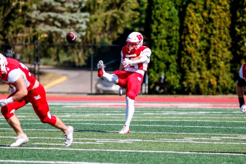 a football player kicking a football