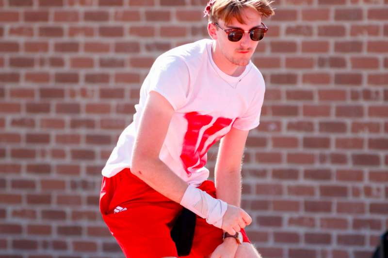 a man wearing sunglasses and a white shirt