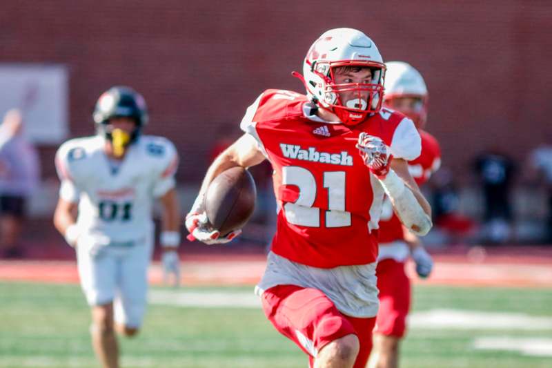 a football player running with a football