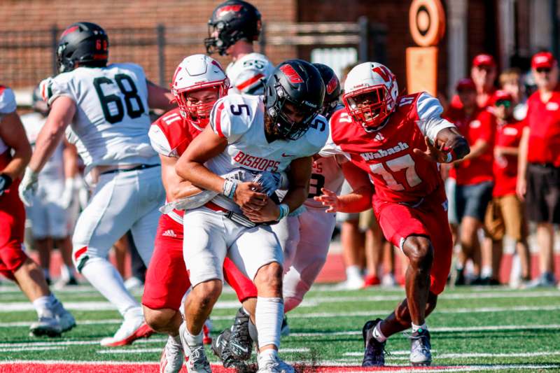 a group of football players running on a field