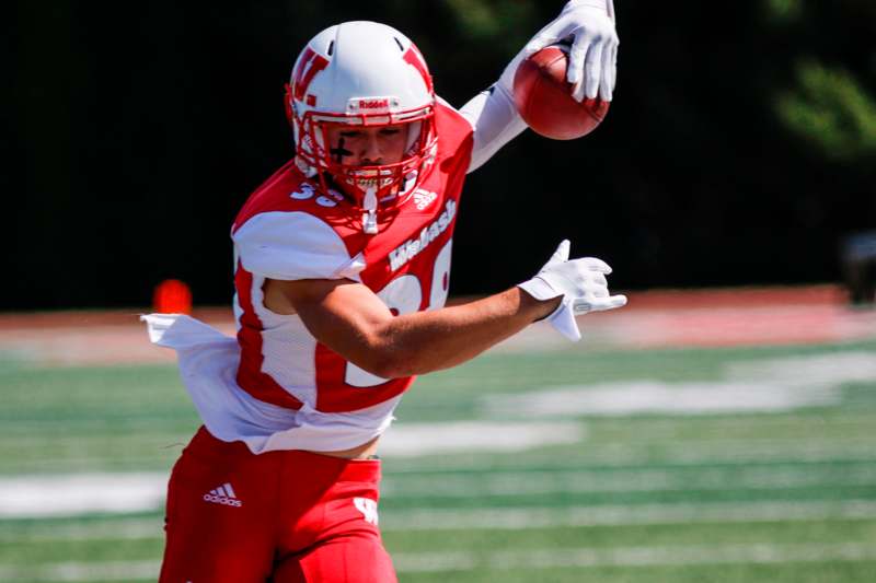 a football player in a red uniform with a football