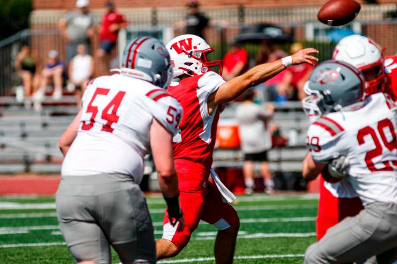 a football player throwing a football