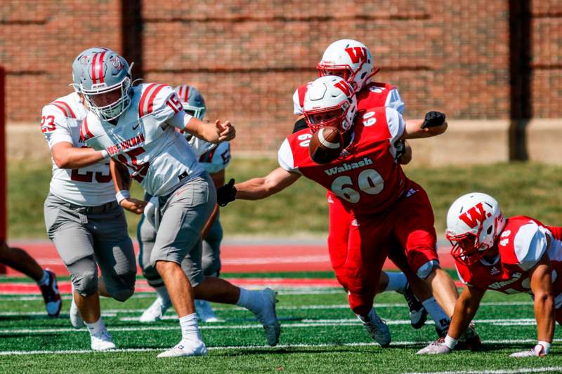 a group of football players running on a field