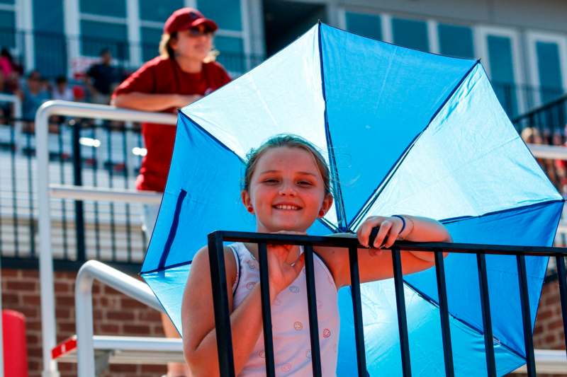 a girl holding a blue umbrella