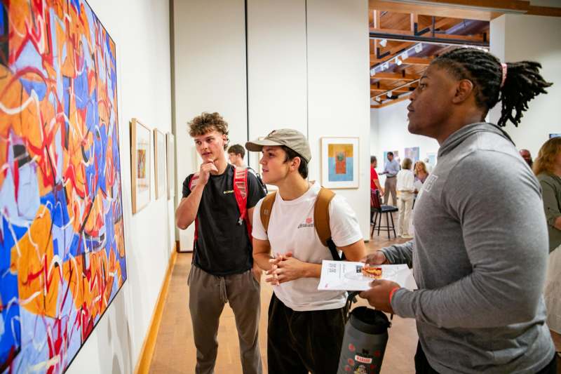 a group of people looking at art