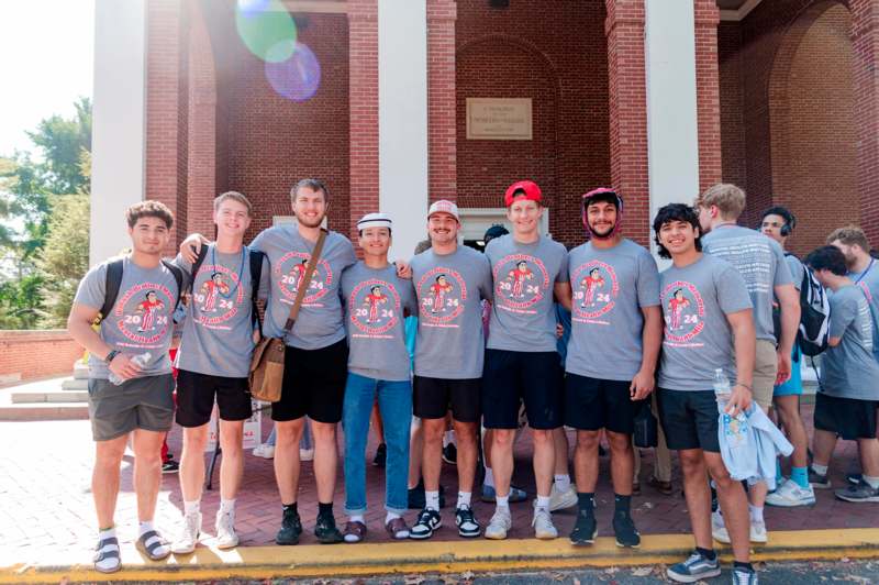 a group of people standing together in front of a building