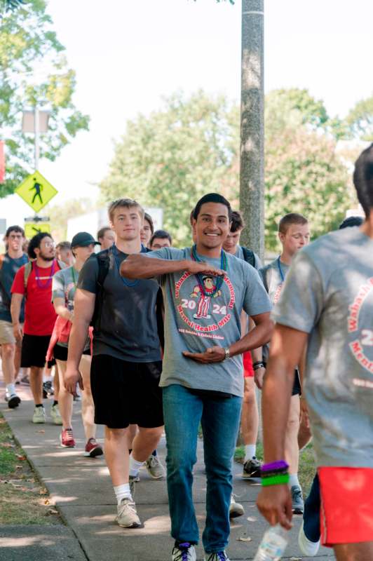 a group of people walking on a sidewalk