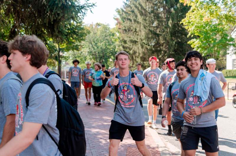 a group of people walking on a sidewalk