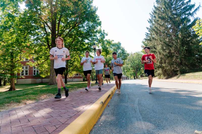 a group of people running on a street