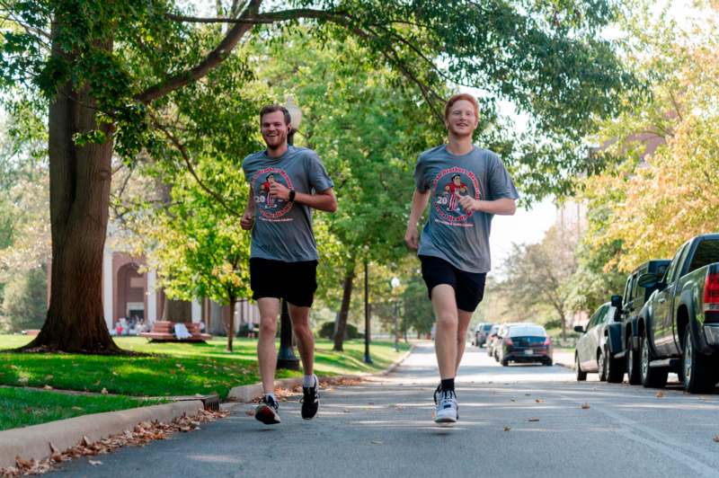 two men running on a street