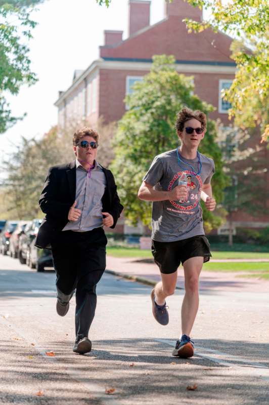 two men running on a street