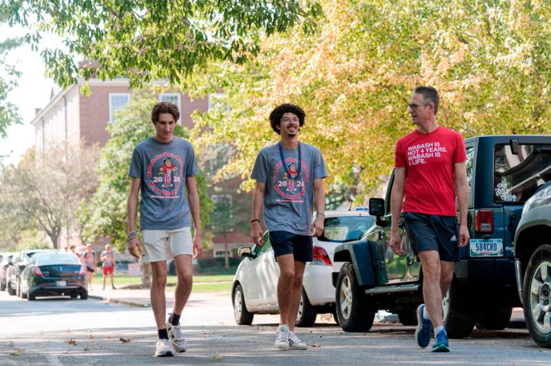 a group of men walking on a street