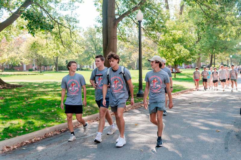 a group of men walking on a path