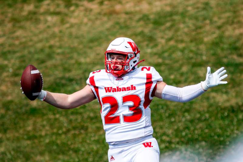 a football player in a helmet holding a football