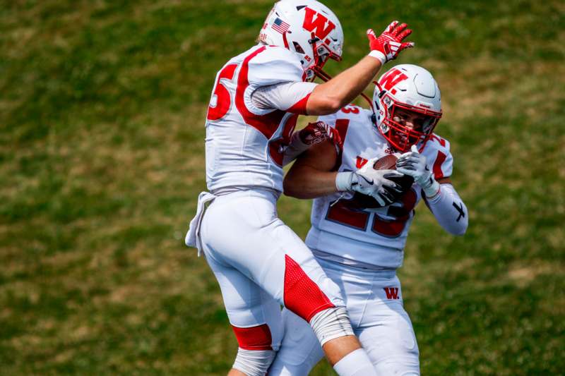 two football players in white and red uniforms