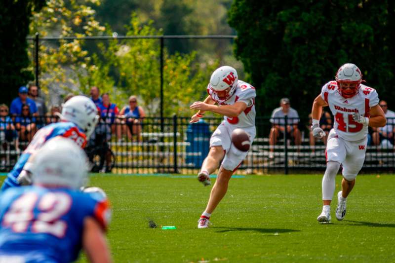 a football player running with a football in the air