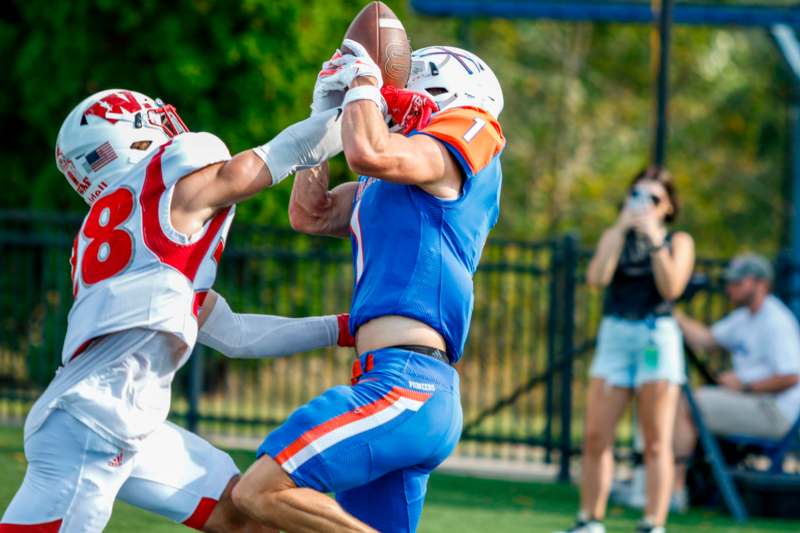 a football player catching a football