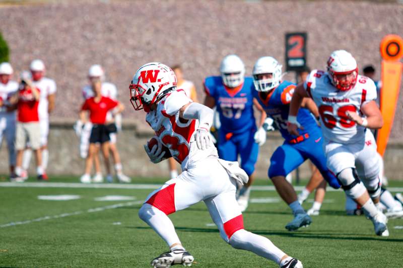 a football player running with the ball