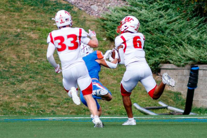 a group of football players running on a field