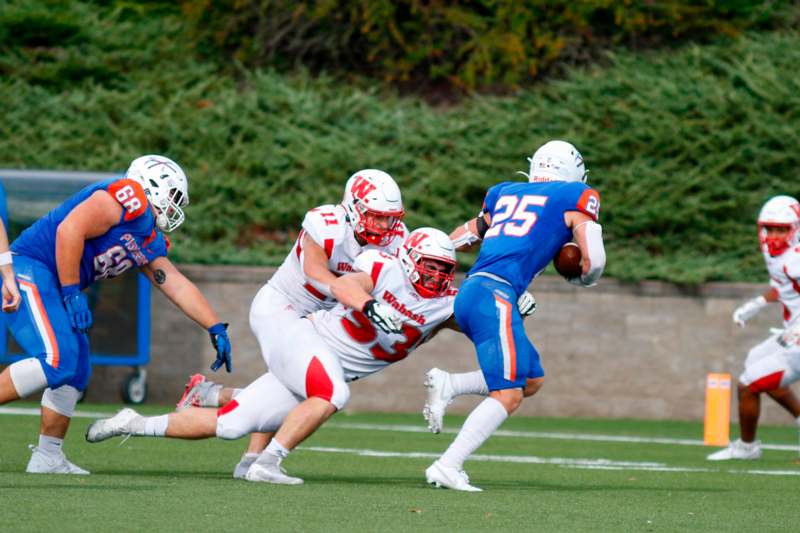 a group of football players running with the ball