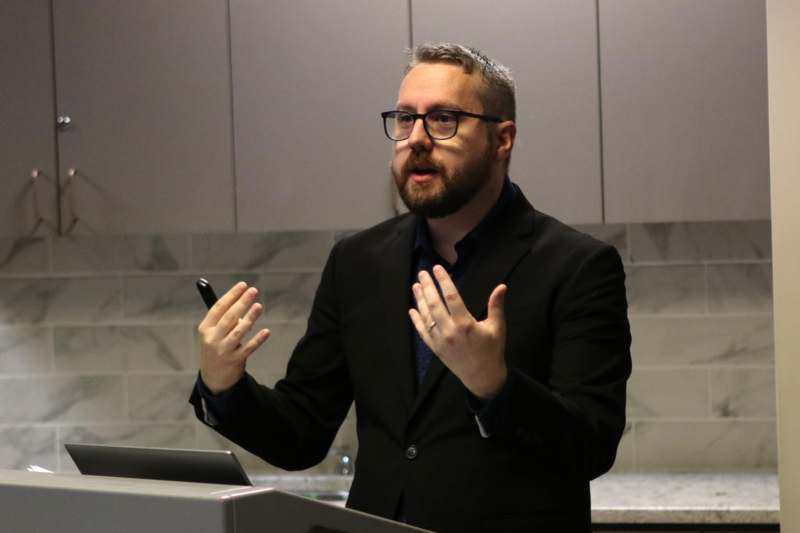 a man in a suit standing at a podium