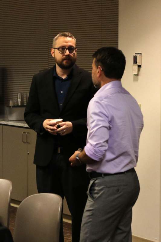 two men standing in a room