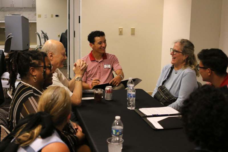 a group of people sitting around a table