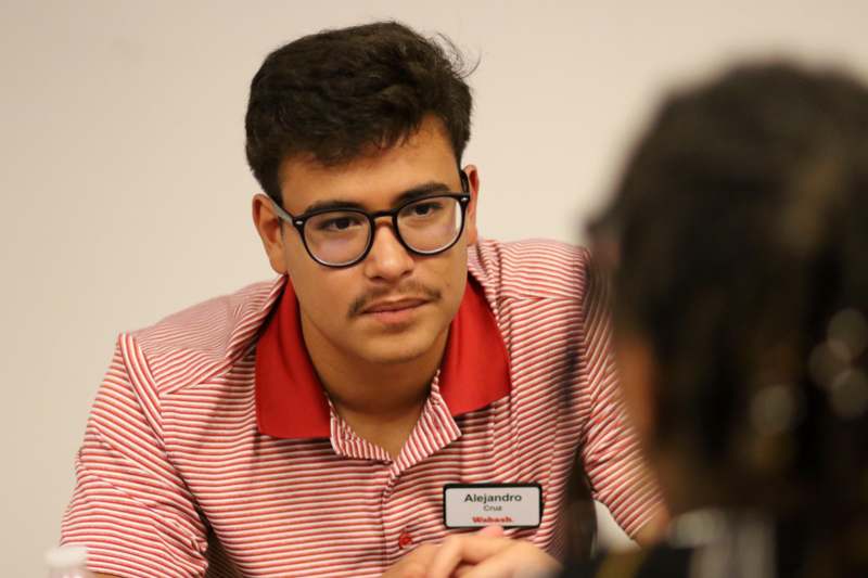 a man wearing glasses and a red and white striped shirt