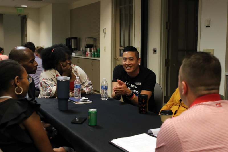 a group of people sitting around a table