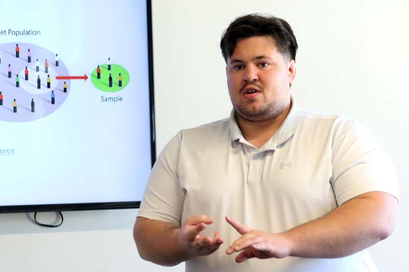 a man standing in front of a screen