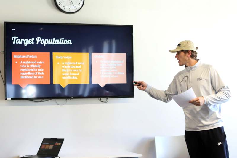 a man standing in front of a screen