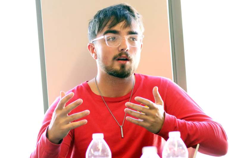 a man in red shirt with glasses