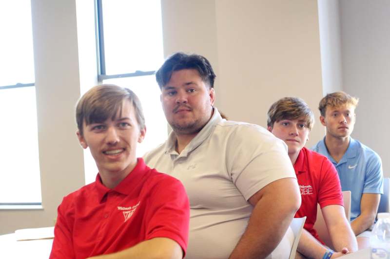 a group of men sitting in a room