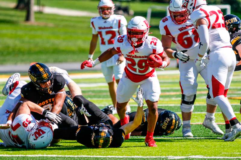 a football player falling down while another player is falling