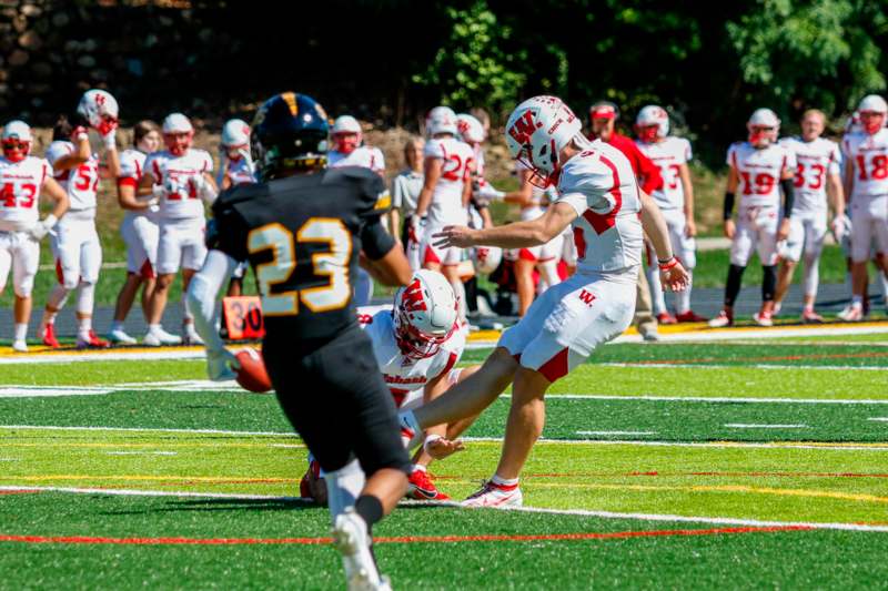 a football player running with a football in the back