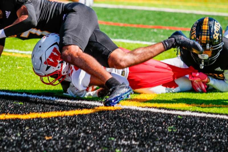 a football player falling on the ground