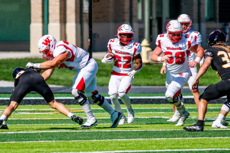 a group of football players running on a field