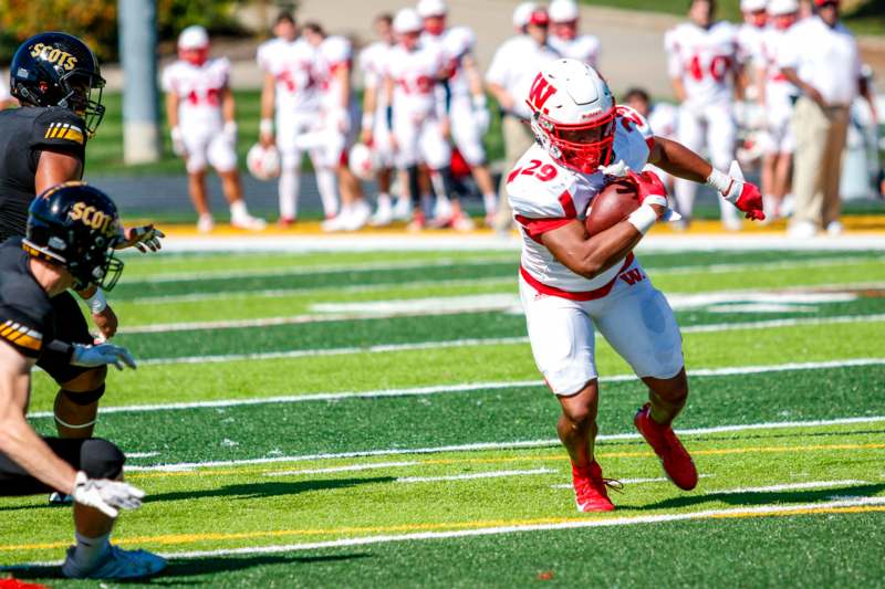 a football player running with a football