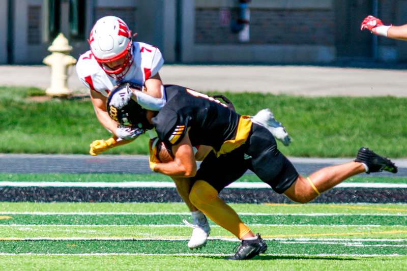 a football player being tackled by another football player