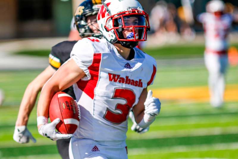 a football player holding a football