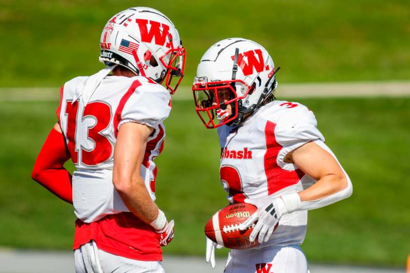 two football players in helmets