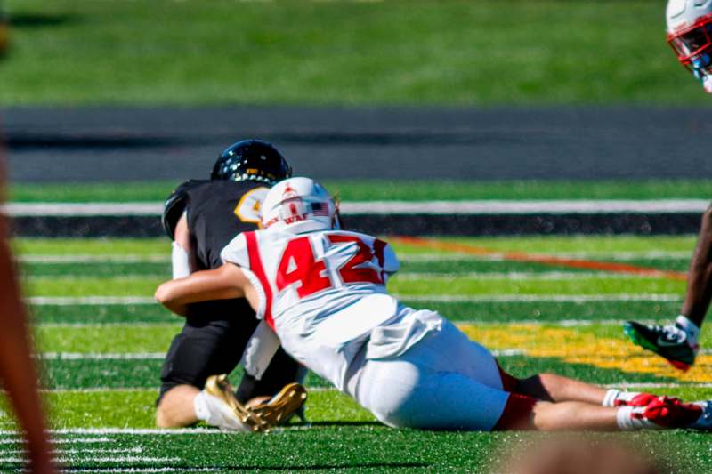 a football player falling down to the ground