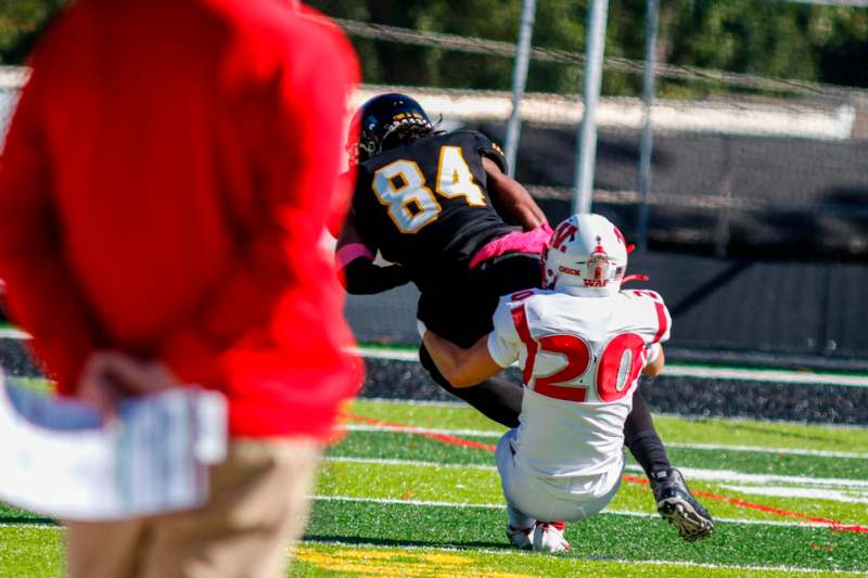 a football player falling into another football player